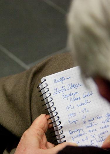 Person writing in a note book
